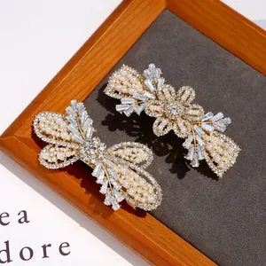 Luxury pearl hair clips with crystal inlay on golden metal for elegant women's styling