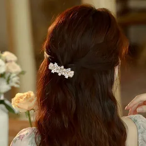 Luxury zircon pearl hair clip with crystal accents worn on elegant half-up hairstyle