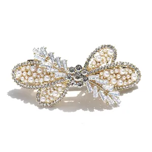 Elegant butterfly hair clip with pearls, zircon, and crystals on a gold alloy base