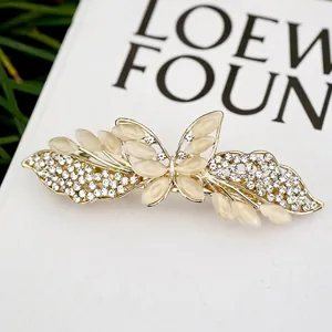 Eleganter goldener Schmetterlings-Haarclip mit Katzenaugensteinen und Kristallakzenten