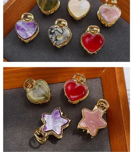 Detailed close-up of mini acetate hair claws with heart and star shapes in various colors