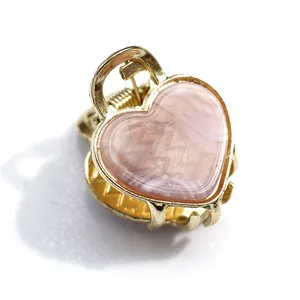 Pink heart acetate hair claw clip with golden metal frame and marble pattern design
