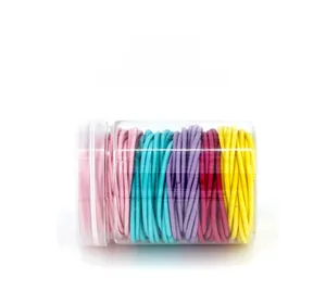 Vertical arrangement of high-elasticity macaron hair ties in a clear cylindrical jar