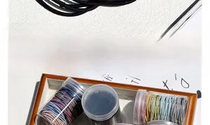 Close-up of elastic hair bands in a jar, showcasing stretchability and macaron colors