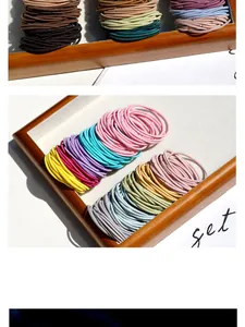 Close-up of elastic hair ties in Macaron and earth tones on a wooden tray