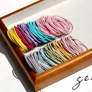 Colorful high-elastic seamless hair ties set displayed on a wooden tray with soft lighting