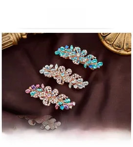 Detailed view of hollow flower hair clips set with sparkling crystals and rose gold base