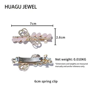 Pince à cheveux noeud doré élégante avec cristal rose et strass scintillants