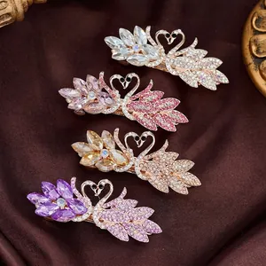 Luxurious swan-shaped crystal hair clips set in pink, white, purple, and champagne gold