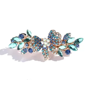 Elegant floral bow hair clip with blue rhinestones and gold alloy spring clasp