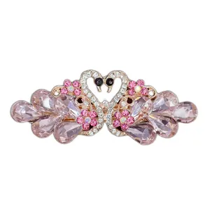 Elegant swan hair clip with pink crystals and rhinestones in heart shape on gold base