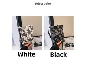 Detail view of mini crossbody phone bags in black and white cow print with m logo