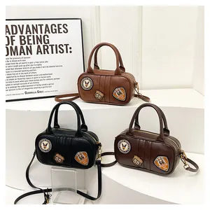 Detail view of retro mini Boston bags with vintage embroidery and gold zipper hardware