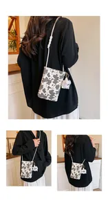Chic cow print canvas crossbody phone bag featuring a cute white plush lamb pendant
