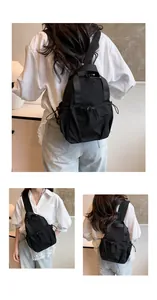 Detail of waterproof black nylon backpack with drawstring pockets and adjustable straps