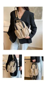 Detail view of khaki nylon pleated backpack with drawstring pockets and adjustable straps