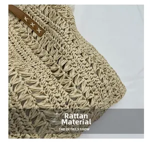 Detail view of woven straw texture and premium brown leather handle of beach tote bag