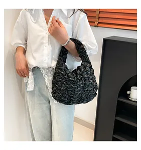 Detailed view of the black ruched cloud bag showing the pleated silk fabric texture