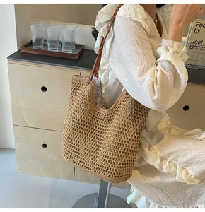 Detail of hand-woven mesh tote bag featuring premium leather handles and inner lining