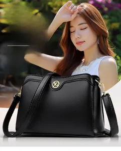 Close-up of black lychee grain leather handbag with gold YG logo and elegant metal hardware