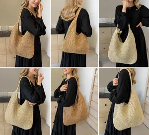 Detail view of woven straw tote bags in dark brown and cream white on a model