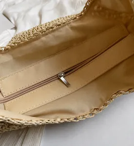 Detail shot of smooth metal zipper and durable inner lining of woven paper tote bag