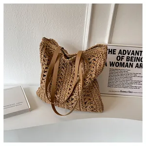 Detailed close-up of the intricate hand-woven straw texture and brown leather straps