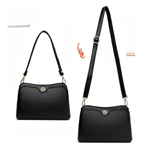 Detail showing two detachable straps for crossbody or shoulder carry on black pebbled leather bag