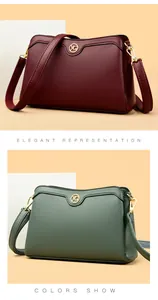 Detail of burgundy and sage green crossbody bags with lychee grain leather and gold hardware