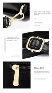 Detail of black lychee leather bag with gold-tone metal hooks and engraved zipper pulls