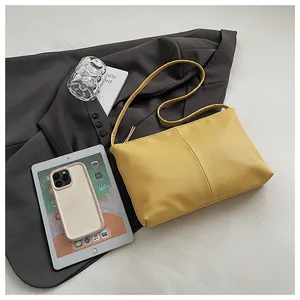 Close-up of bright yellow lychee grain leather shoulder bag with sleek rectangle design