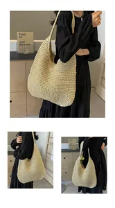 Detailed close-up of handmade woven straw shoulder bag featuring a large capacity hobo design