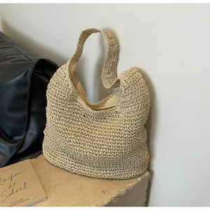 Detailed close-up of handmade woven straw tote bag with textured crochet and inner lining