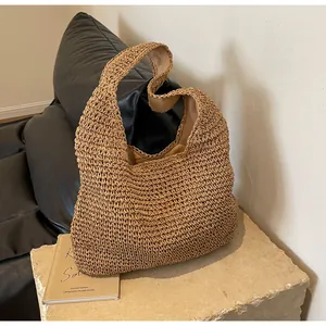 Detail of cross-woven paper rope texture and inner lining of the large straw tote bag