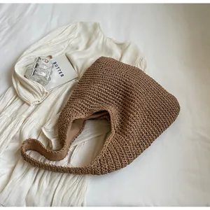 Detailed close-up of a large coffee brown handmade woven tote bag on white fabric background