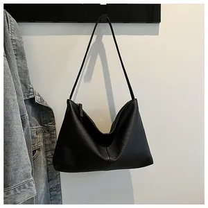 Close-up of black lychee texture leather shoulder bag with metallic silver zipper detail