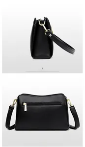 Detail of black lychee grain leather bag showing gold hardware and back zipper pocket