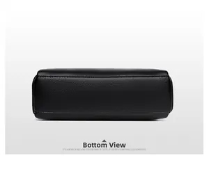 Detail view of the rectangular bottom of the black lychee leather crossbody bag