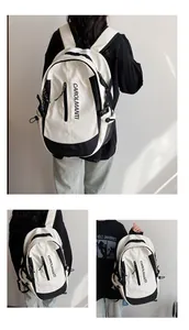 Détail d'un sac à dos contrasté noir et blanc avec poches zippées multiples et nylon résistant