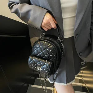 Black quilted mini backpack with rhinestone studs and silver chain strap for women