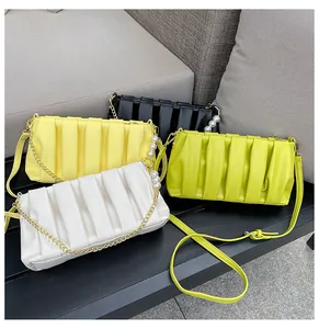 Detail of pleated cloud bags in four colors with pearl chains and metal chain straps