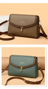 Close-up of elegant leather crossbody bags with gold metal locks and adjustable straps