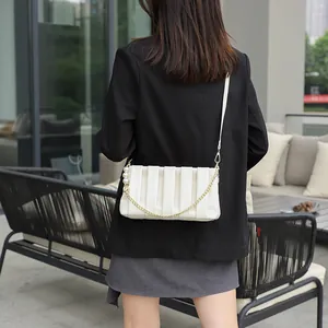 Chic pleated off-white shoulder bag with golden chain and pearl accents for women