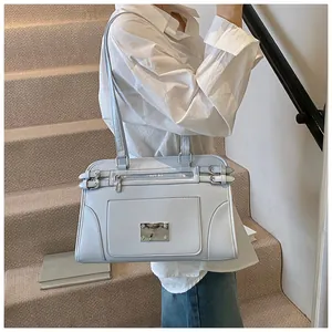 Close-up of light blue faux leather tote with silver metal plate and buckle detail