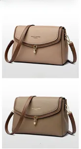 Close-up of pebble grain leather handbags in light and dark khaki with gold hardware