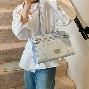 Light blue-grey faux leather shoulder bag with buckle details and spacious interior design