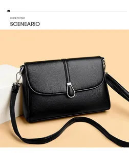 Close-up of black lychee grain leather handbag with silver metallic ring and long strap