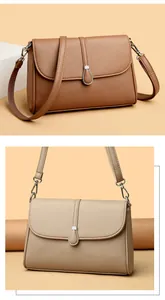 Close-up of litchi texture leather handbags in brown and beige with teardrop metal buckle