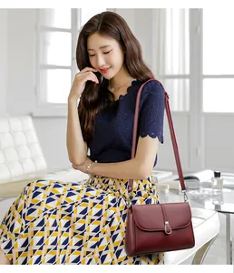 Deep burgundy leather crossbody bag with lychee texture and silver U-shaped metal lock