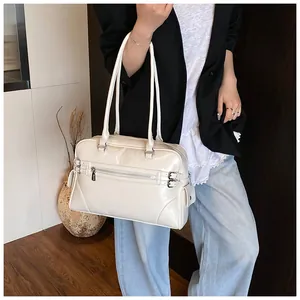 Detailed view of white high-gloss tote bag with silver zippers and long handles